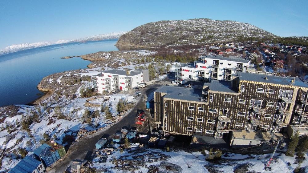 Blocks of flats on the hillside above the fjord, seen from the air